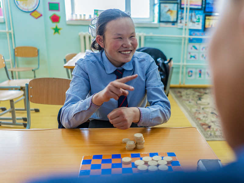 Oyunjargal plays checkers with a friend at school. Murun, Mongolia. Credit: GPE/Bat-Orgil Battulga
