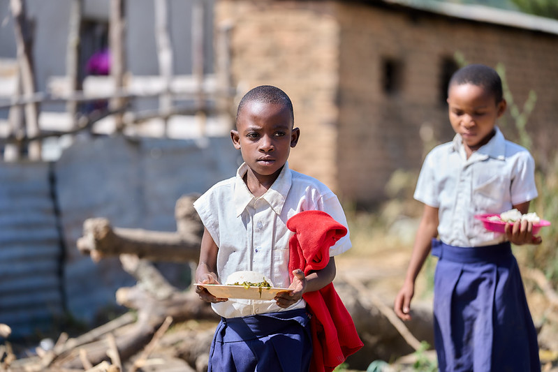 Students at Idugumbi Primary School, Mbeya, Tanzania, enjoy their lunch, thanks to the school feeding program.  Credit: GPE/Mrutu (Trans.Lieu)