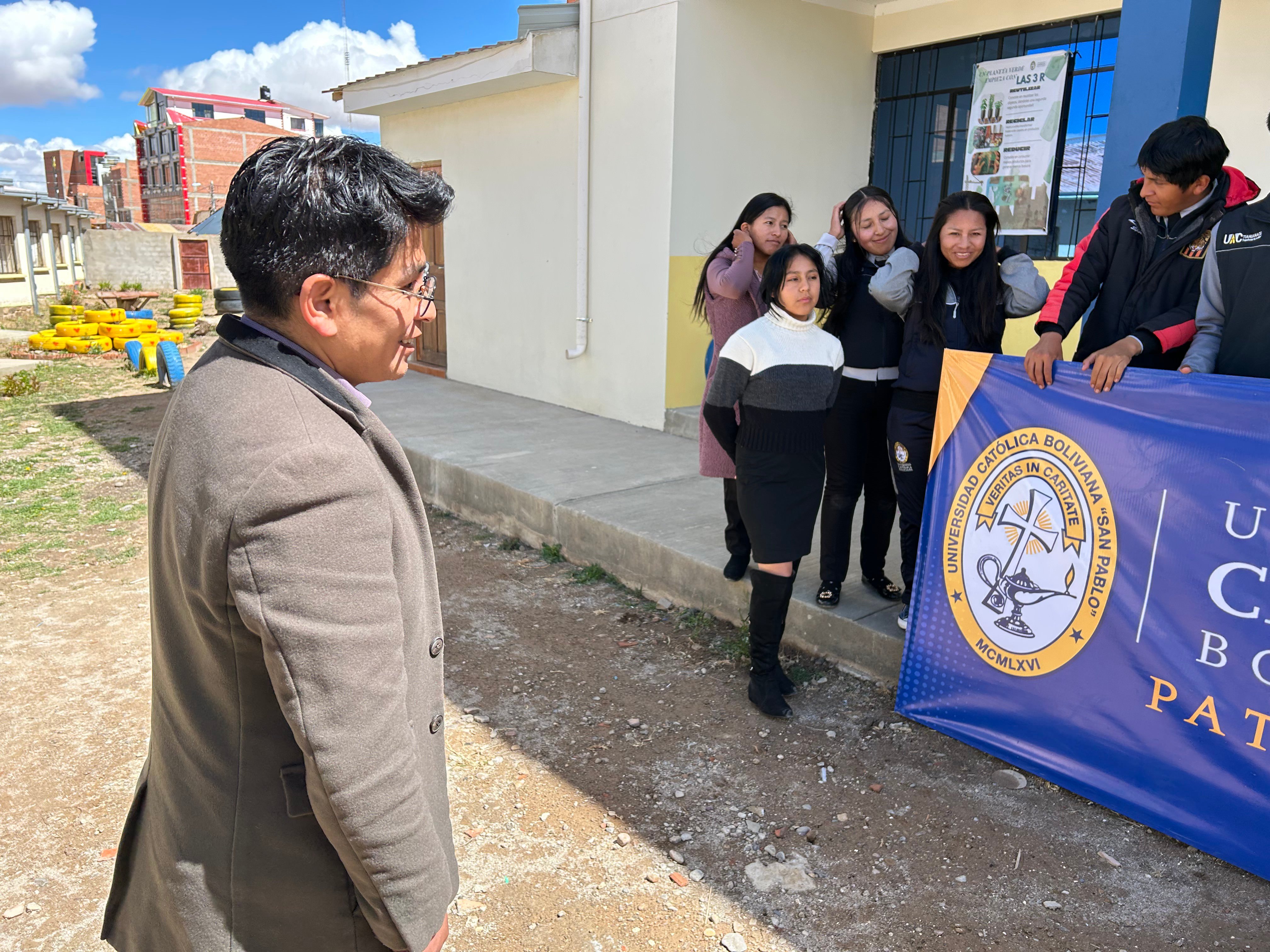 Teacher with students and a banner