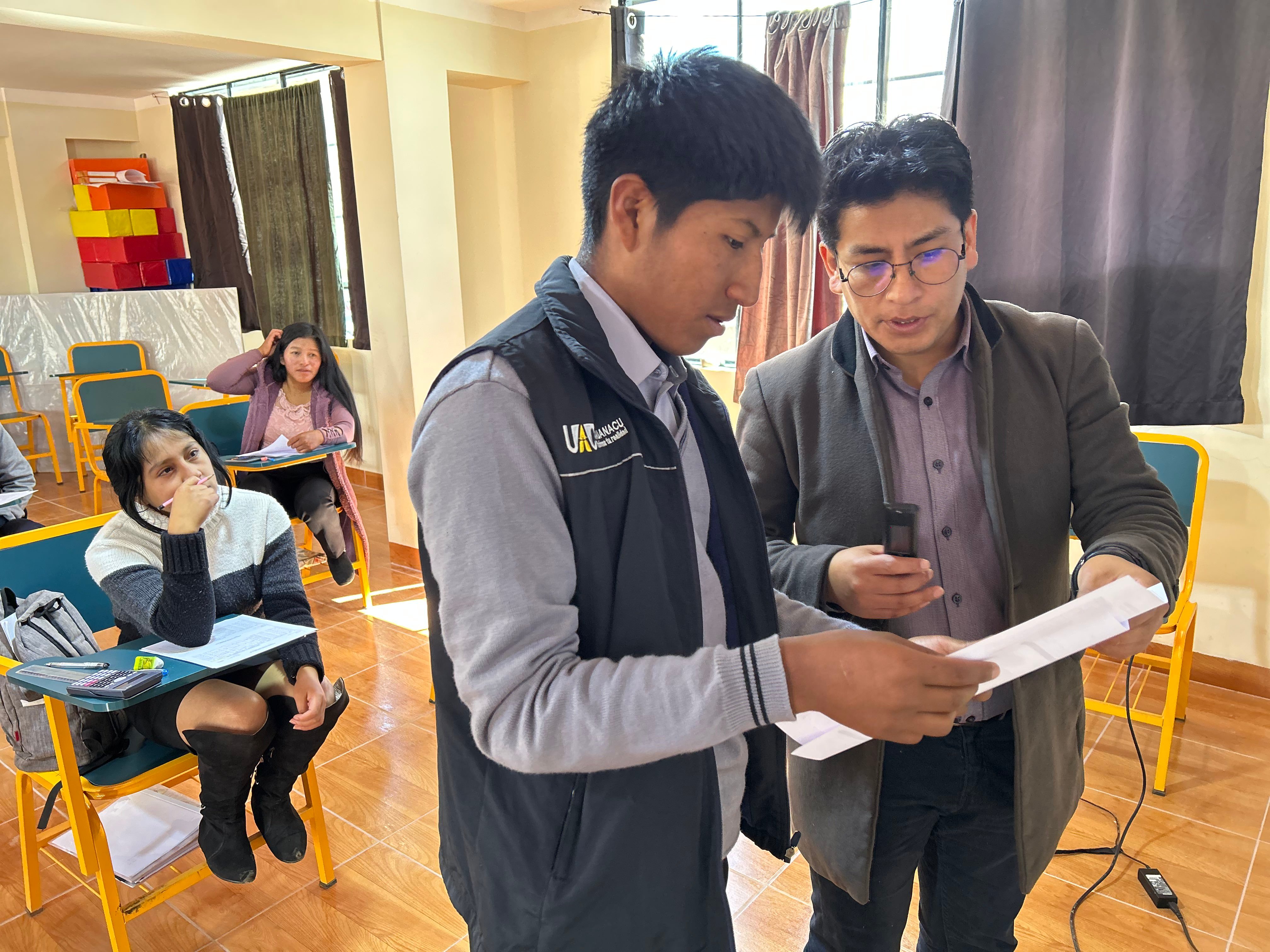Student and teacher looking at a paper